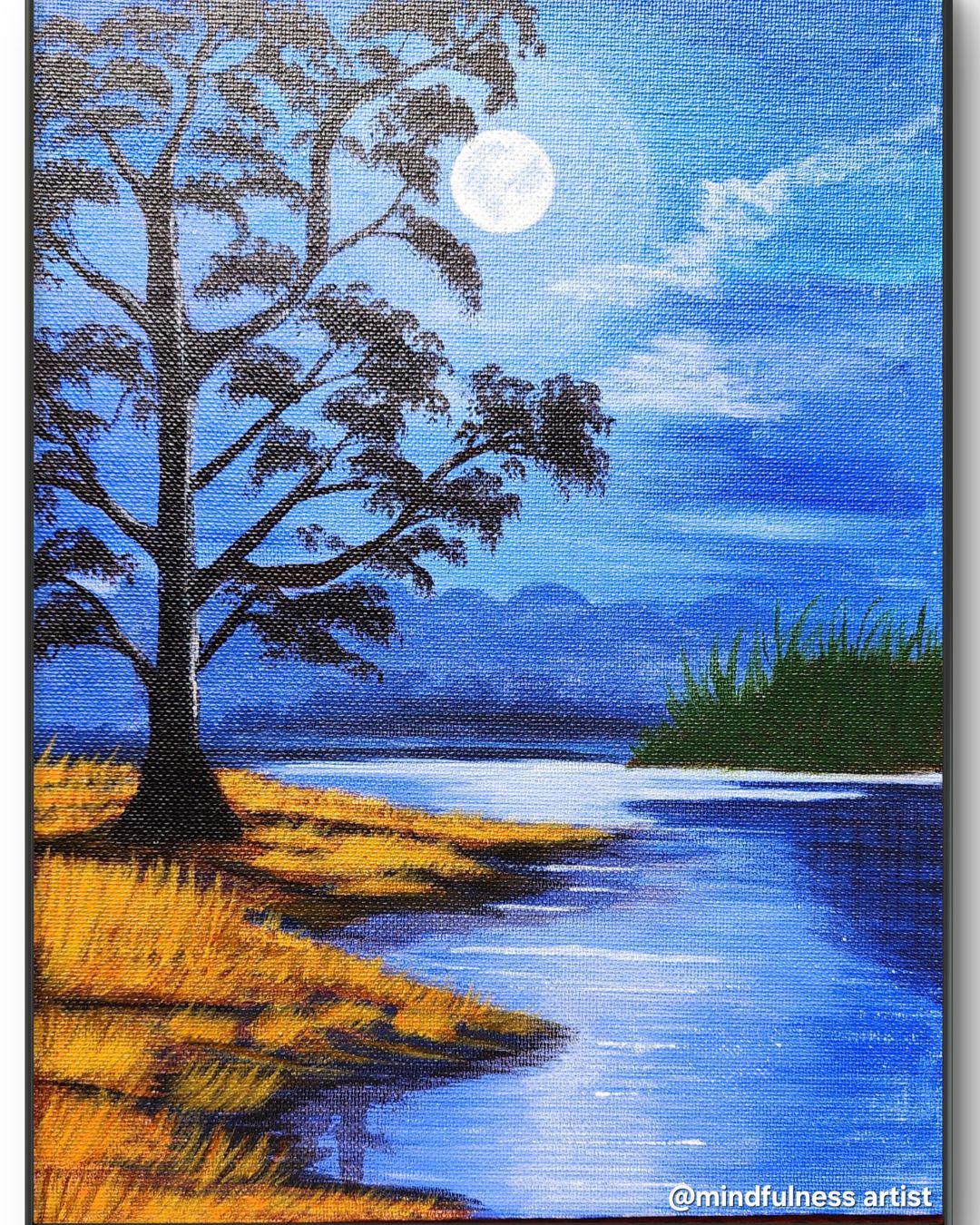 Bathed in moonlight, this serene riverside scene captures the stillness of a quiet night. A lone tree stands tall, its silhouette gently softened by the glow of the full moon. The golden grass along the bank contrasts warmly with the cool, deep blues of the sky and water — creating a sense of harmony between earth and sky. The reflections in the water, the distant mountains fading into misty blues, and the soft clouds drifting past the moon all invite the viewer into a meditative calm. This piece reminds us to slow down, breathe, and simply be present in nature’s quiet beauty.